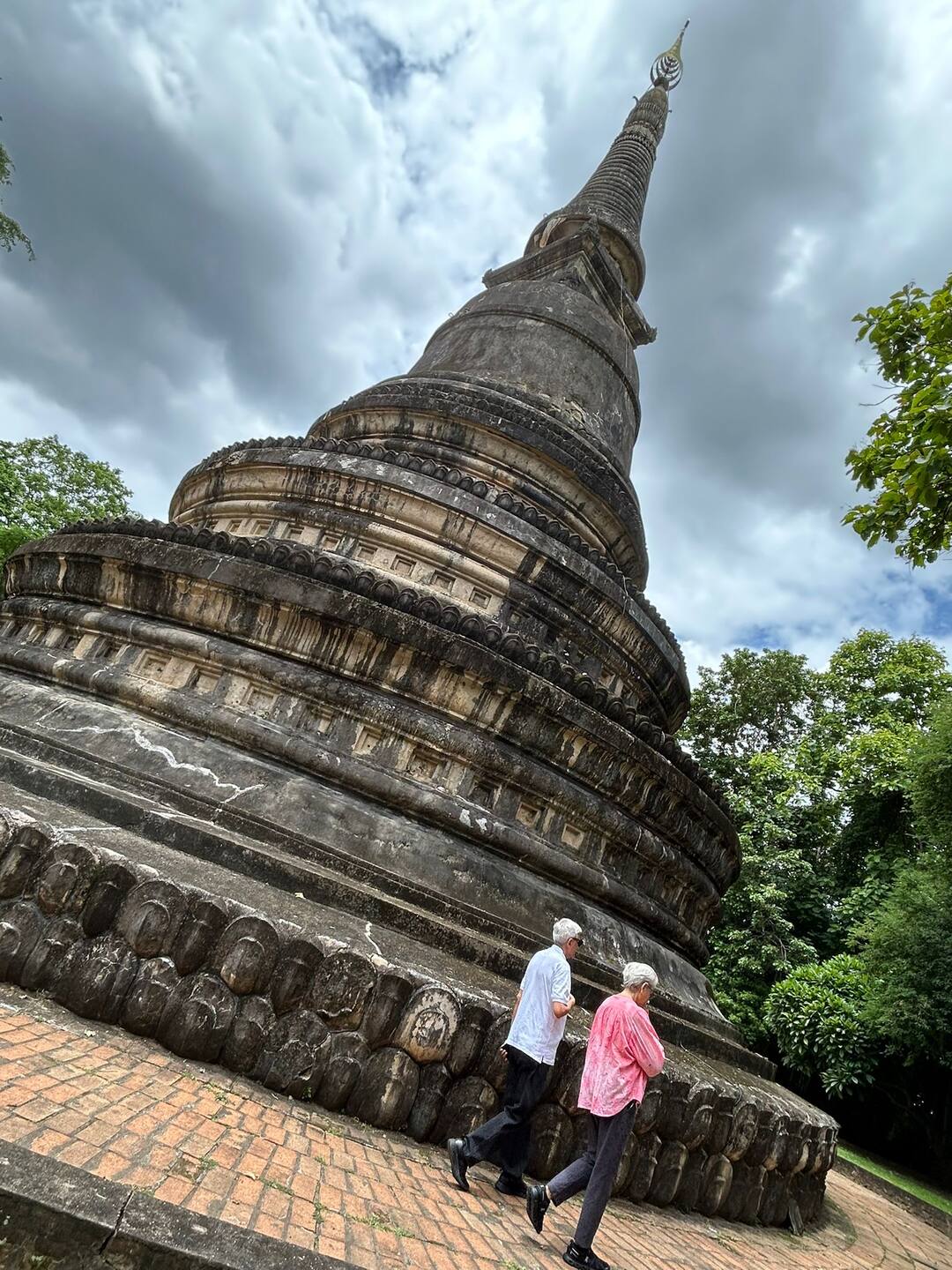 Guests walking past the Wat Umong chedi
